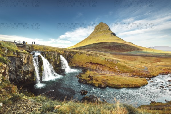 Landscape view of Kirkjufellsfoss In the daytime, blue sky and beautiful clouds. The waterfall is