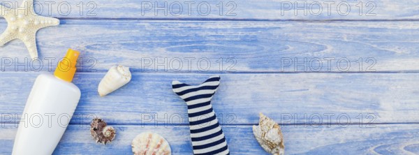 Long wide banner flat lay concept summer travel vacations. Top view of sunscreen bottle mockup