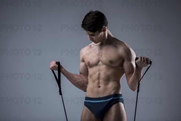 Muscular fit young male antique perfect muscles six packs of abs and bare chest. Bodybuilder model