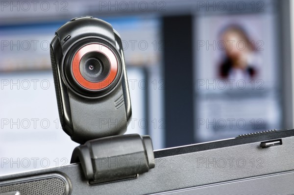Webcam on monitor, in the background a screen with a portrait of a woman, Federal Republic of
