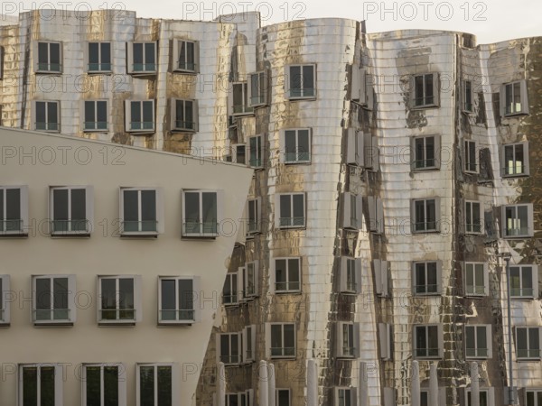 Detailed view of modern, distorted buildings with reflective facades and many windows, düsseldorf,