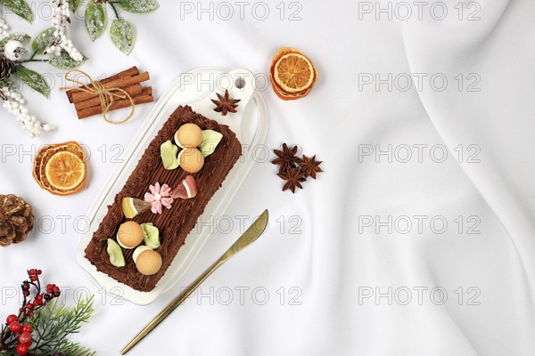 Homemade winter dessert, stollen or strudel with sweet cream filling, nuts, cinnamon and poppy