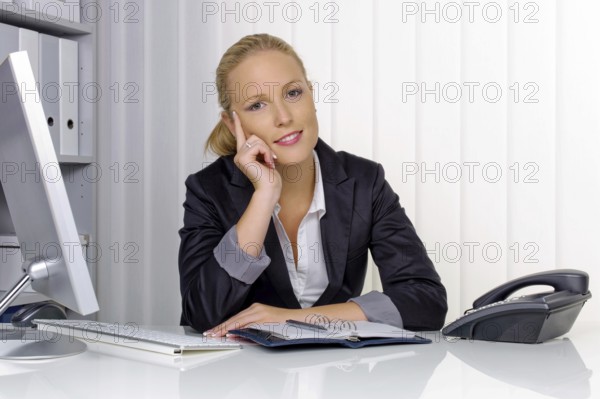 A secretary in the office at her daily work, 35 years, Thoughtful studio shot, Federal Republic of