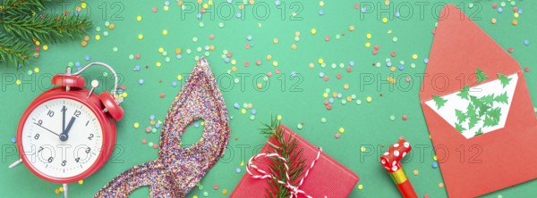 New Year or Christmas pattern flat lay top view with red alarm clock twelve midnight fir tree