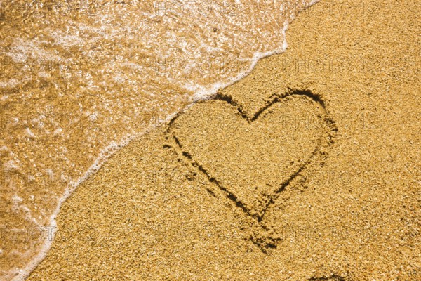 Heart symbol on the sand. Summer holiday concept. Romantic love background. Valentin Day theme. Top