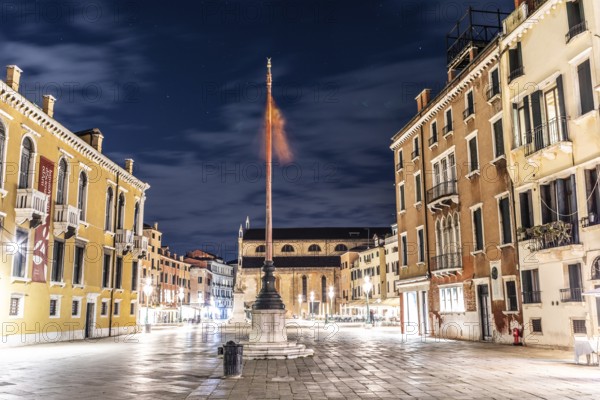 Venetian flag waving in the wind, illuminated facades, Campo Santo Stefano, night shot, Venice,