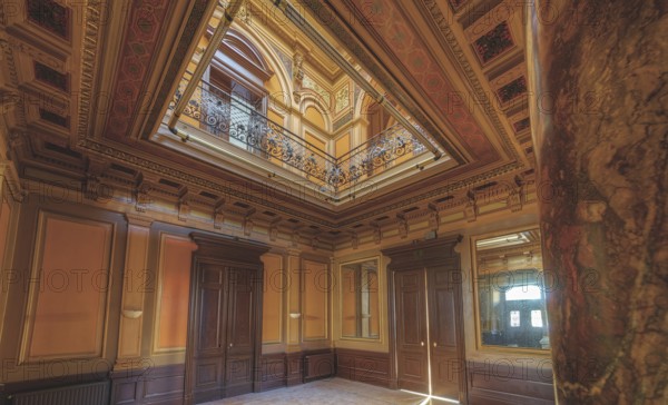 Magnificent staircase with ceiling fresco, framed by columns and elegant wooden doors, Villa