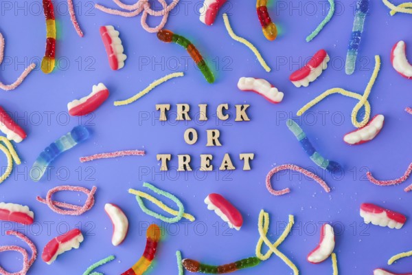 Halloween concept. Halloween party decorations with words TRICK OR TREAT, sweets, top view flat lay