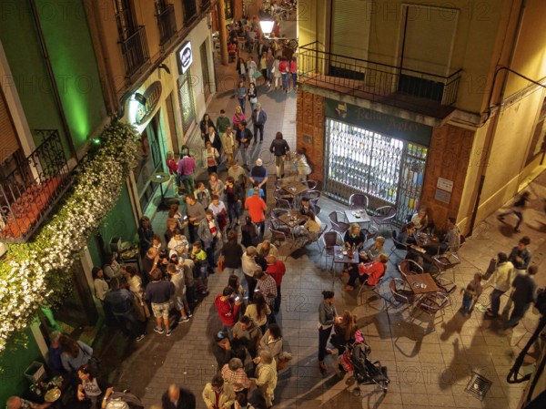People of all ages enjoy a a party on the Torres de Omana Square on a mild autumn evening, Leon,