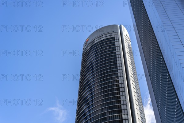 Madrid, Spain, May 10, 2020: Low angle view of office building in the city of Madrid against blue