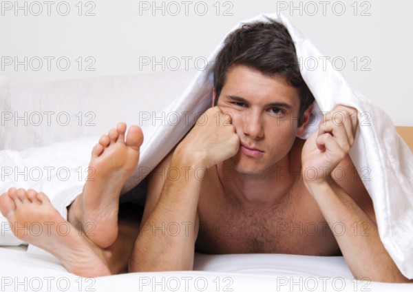 A young couple in bed has problems and a crisis. Divorce and separation. Austria