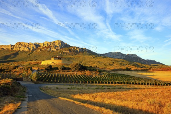 Bright flaming colors of the sunset. The magnificent Bodegas Ysios. Journey to the warm Spanish