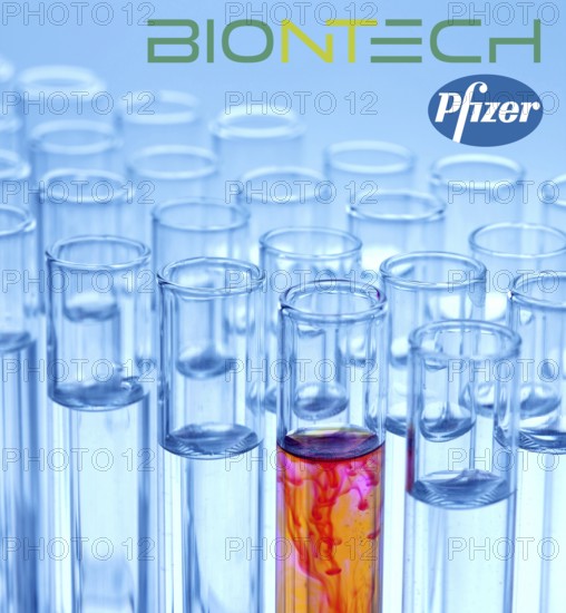 A single syringe, corona vaccine from Biontech and Pfizer, logo, test tubes, laboratory examination