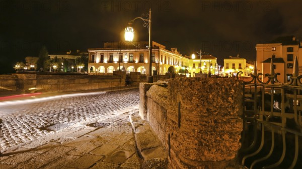 Night time on the historic landmark New Bridge Puente Nuevo of Ronda town in Spain. with running