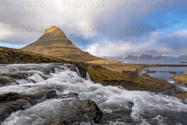The Kirkjufell mountain and the kirkjufellfoss waterfall at grundarfjordur at Snæfellsnes peninsula
