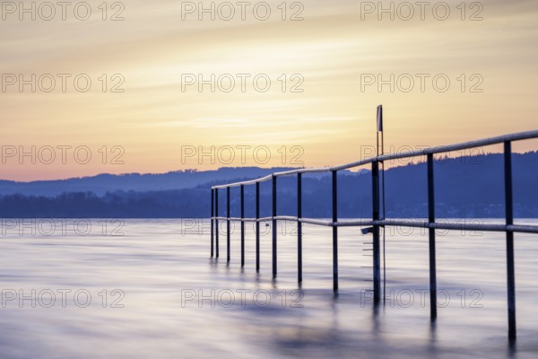 Twilight over the lake with railing, soft sky and calm atmosphere, lido, Litzelstetten, Lake