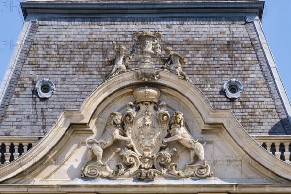 Rampant lions hold up the coat of arms of Festetics family on the tower of Festetics Palace,