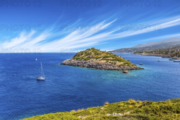 Holiday in Greece, island of Zakynthos. Bright blue sea water reflects coastal cliffs. Snow-white