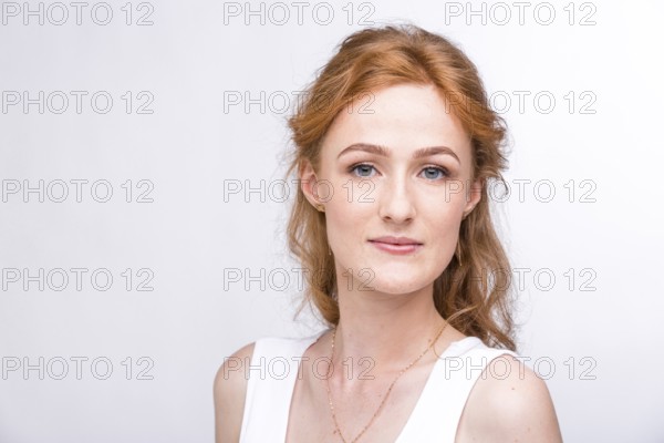 Portrait of a beautiful young woman of European, Caucasian nationality with long red hair and