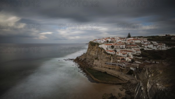 Picturesque village of Azenhas do mar at the top of a rocky hill on the Atlantic Ocean. Long