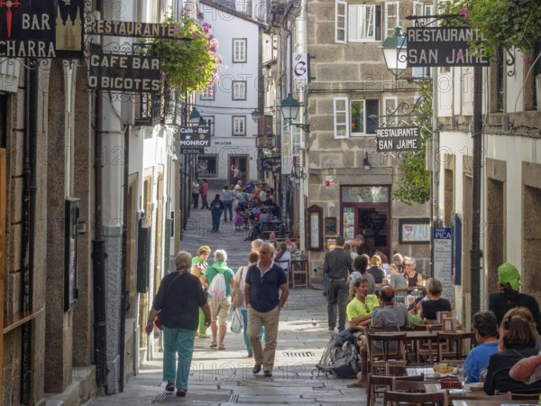 Tourists and locals stroll and dine on Raina Street (Rua da Raina), Santiago de Compostela,