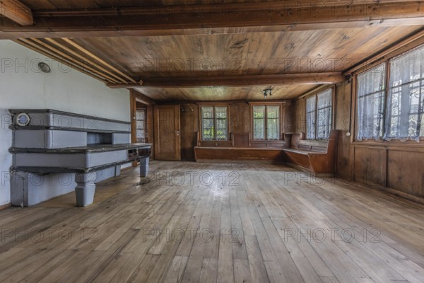The living room with tiled stove and wooden corner bench in a house built around 1750 that has
