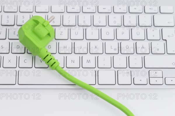 Green power plugon a keyboard isolated on white background