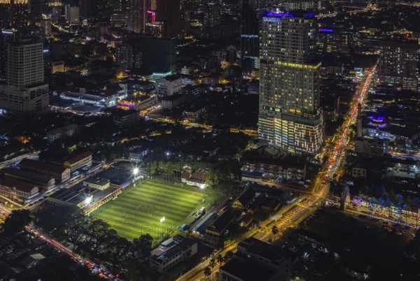 A picture of the EV Arena Kelab Sultan Sulaiman football field, and the Tamu Hotel and Suites Kuala