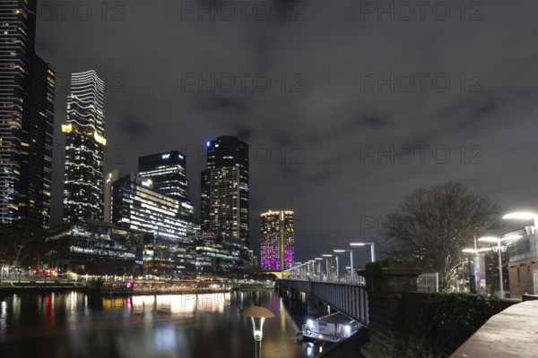 MELBOURNE, AUSTRALIA - JULY 5, 2024: Melbourne skyline as seen at dusk from Sandridge Bridge near