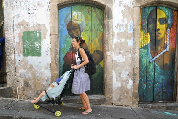 Tourist walking in the colorful historic district of Pelourinho, Bahia, Brazil. Historic