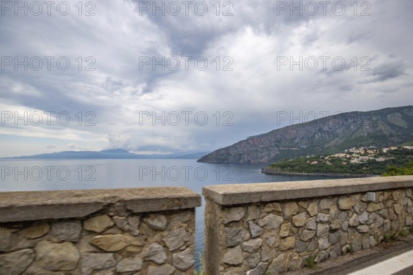 Coastal landscape shot. View from a road leading along the sea and through a breathtaking green