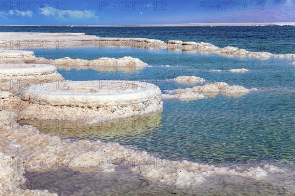 The evaporated salt forms bizarre crystal shapes on the surface of the water. Israeli coast, warm