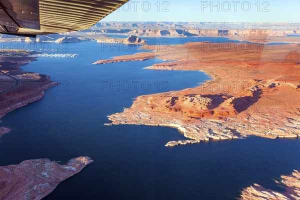 Landscape under the wing of an airplane. Lake Powell is a reservoir on the Colorado River located