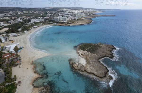Aerial drone view of the coastline of empty beach in winter. Summer holidays. Nissi beach bay Ayia