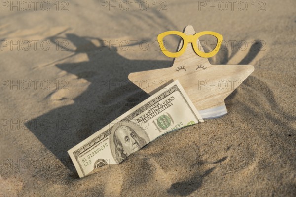 Money american hundred dollar bills in sandy beach with starfish. Concept finance saving money for