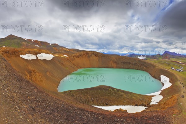 July in Iceland. Lake in the crater of an extinct volcano. Lake water bright green color. On the
