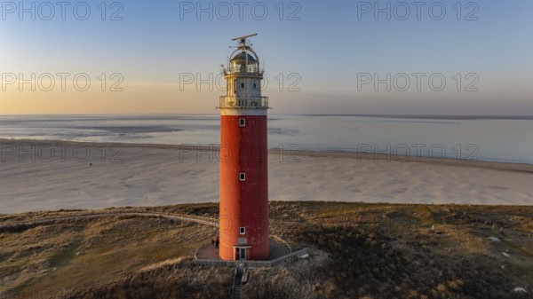 Aerial view of the northern end of the island of Texel with beach and lighthouse in sunshine, De