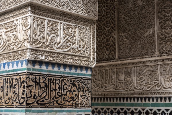 Fes, Morocco, April 04, 2023, Rich decorated facade in the courtyard of the Medersa Attarine in
