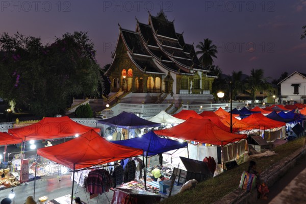 Night market in front of the Buddhist temple Haw Phra Bang of the Royal Palace, National Museum on