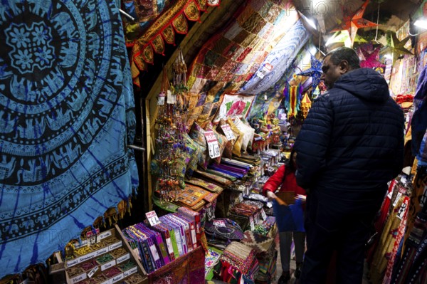 A vibrant market stall showcasing colorful textiles and tapestries in the London Borough of Camden,