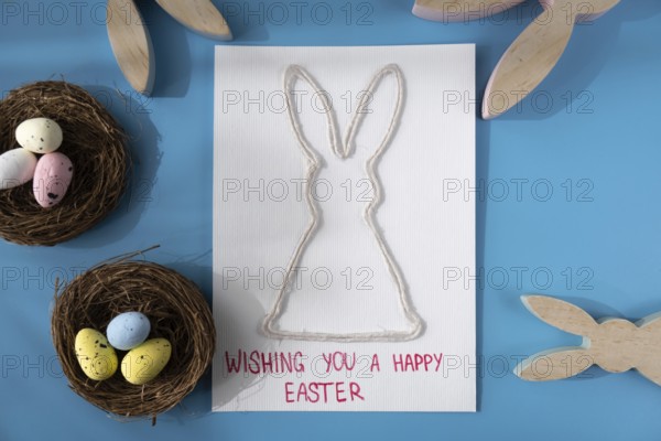 Handmade greeting card with EASTER bunny HAPPY EASTER written in beautiful handwriting. Gesture