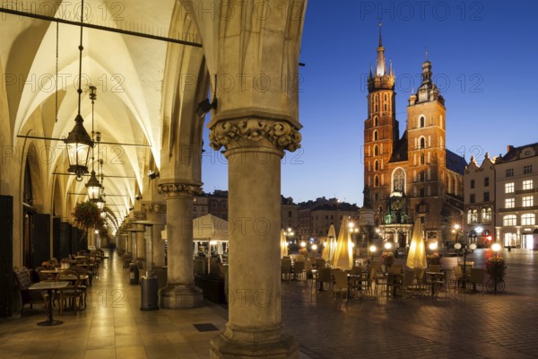 City of Krakow by night in Poland, Main Square in the Old Town with St. Mary Church from the arcade