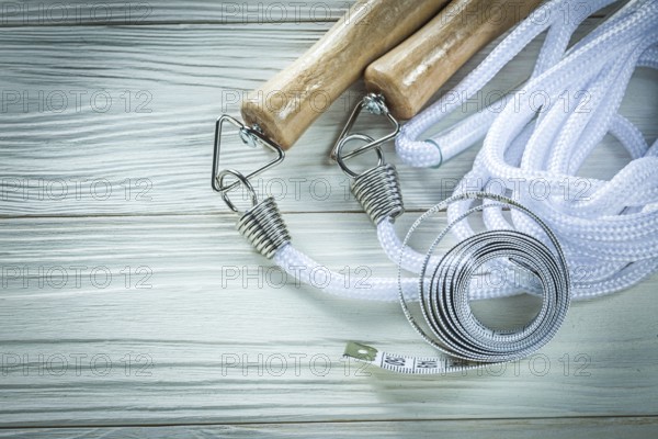 Skipping rope Tape measure on wooden board Fitness concept
