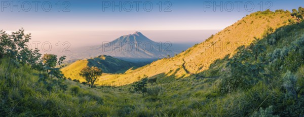 Panoramic photo of mountains surrounding Mount Merbabu near Yogya in central Java province in