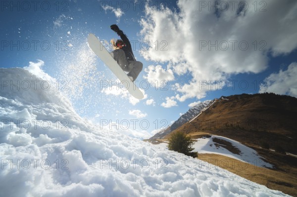 Extreme winter sports. Young professional woman snowboarder rides a halfpipe. Jumps from a halfpipe