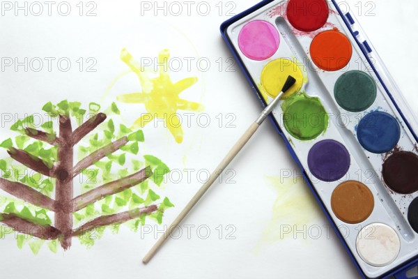 Children's drawing and watercolor paints with brush