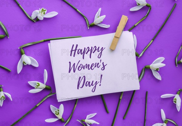 Happy Womens Day lettering greeting card. Spring flowers snowdrop. Beautiful tender bouquet of