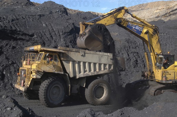 WESTPORT, NEW ZEALAND, CIRCA 2007: Digger loads up a truck with high grade coal at Stockton Coal