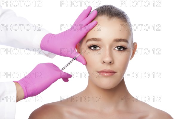 Beautiful face crows feet injection Cosmetic skincare spa beauty treatment with pink gloves by eye,