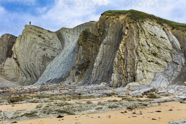 Coast of the Atlantic Ocean. Cantabria. Noon on the beach of Playa di Arnia, Spain. Photographer
